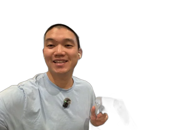 Kevin holding a DualSense controller in front of a wall-mounted display running a terminal — vibe coding with ControllerKeys