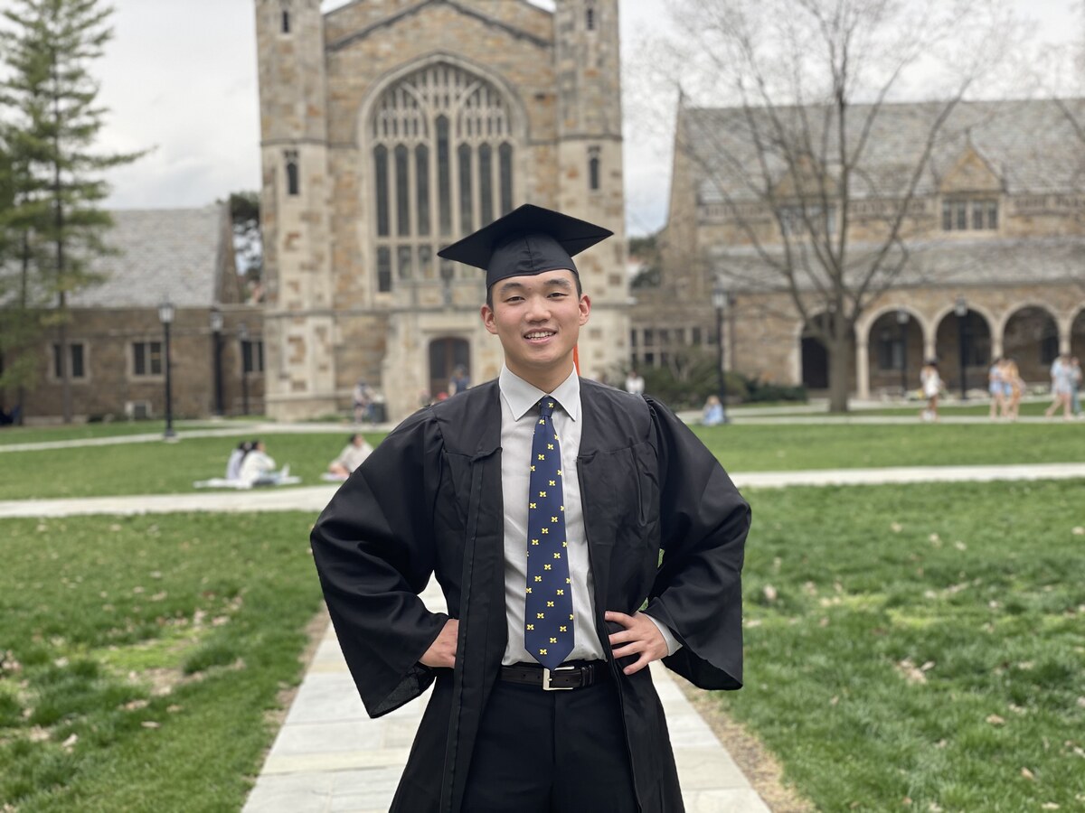 Kevin in cap and gown at the University of Michigan Law Quad